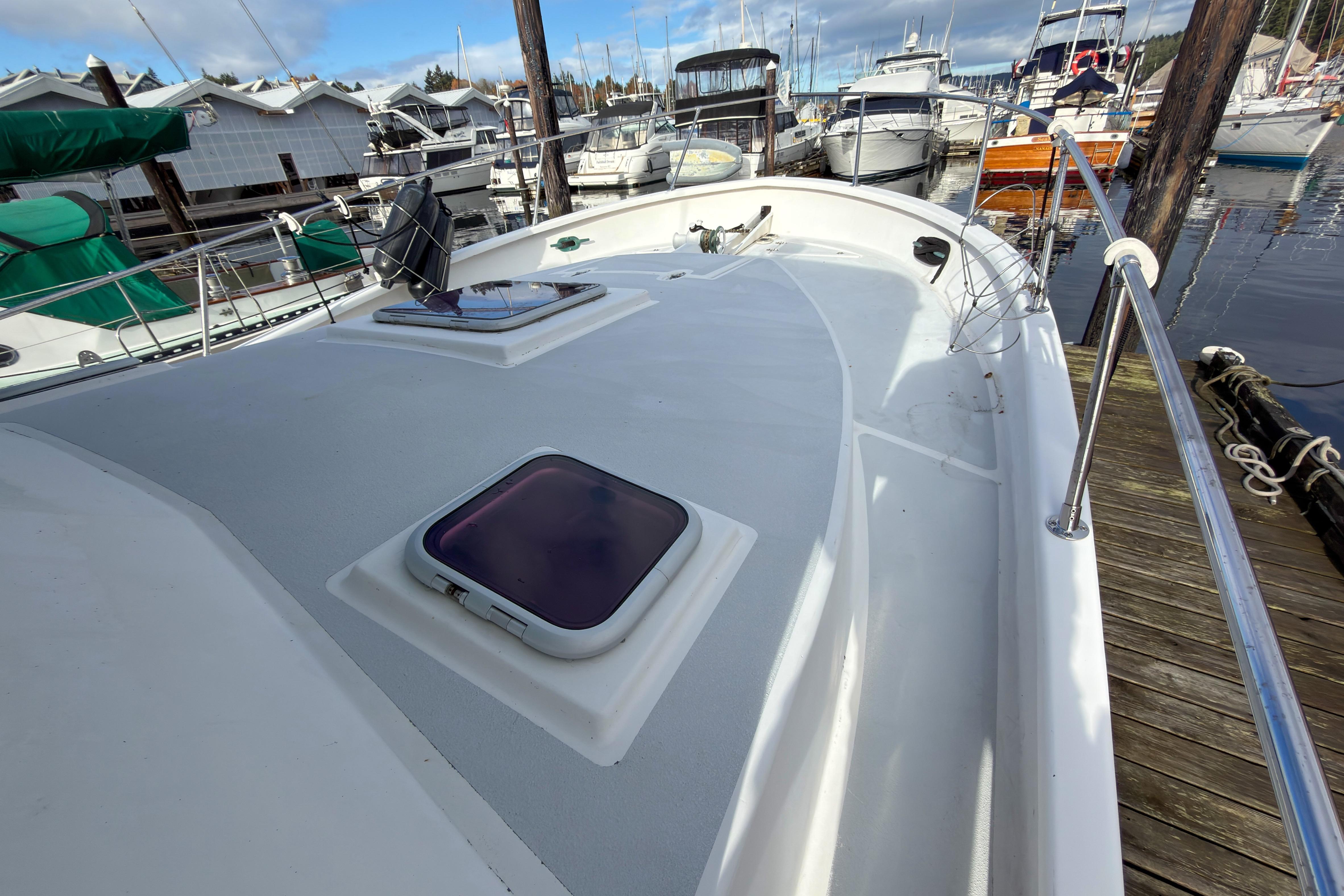2014 Farrell 34 Pilothouse boat docked at a marina with other vessels.
