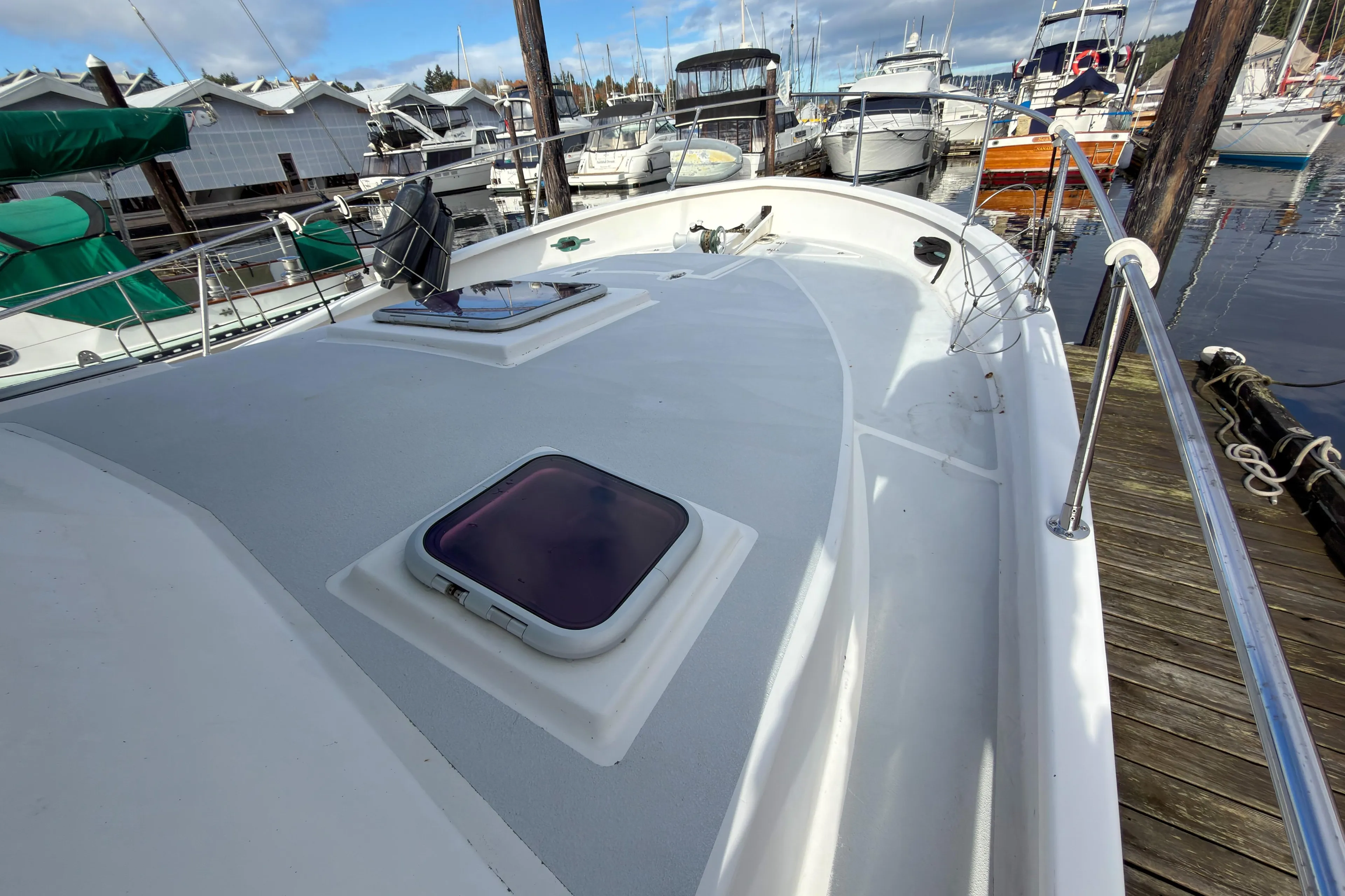 2014 Farrell 34 Pilothouse boat docked at a marina with other vessels.