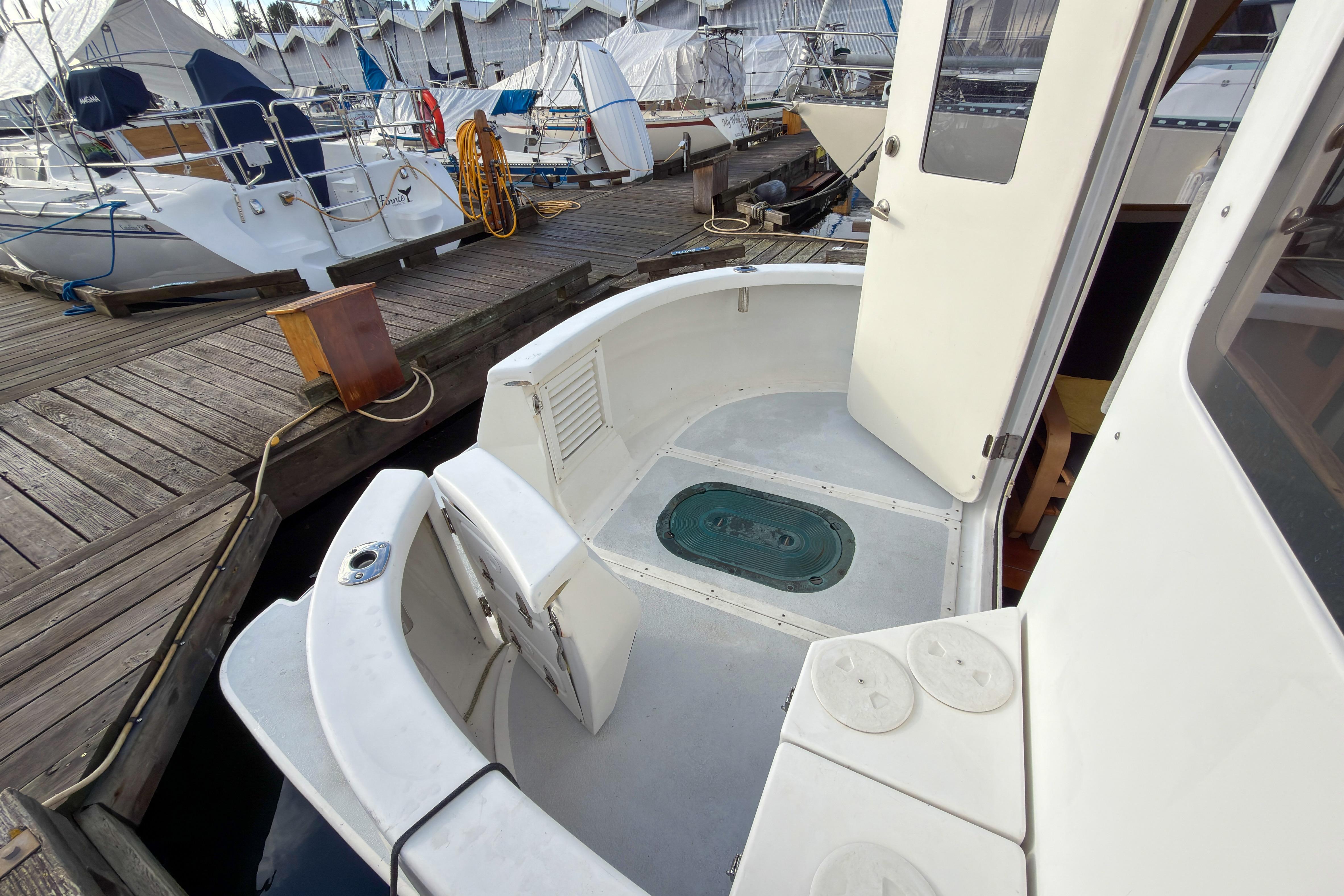2014 Farrell 34 Pilothouse boat docked, showing open door and deck area.