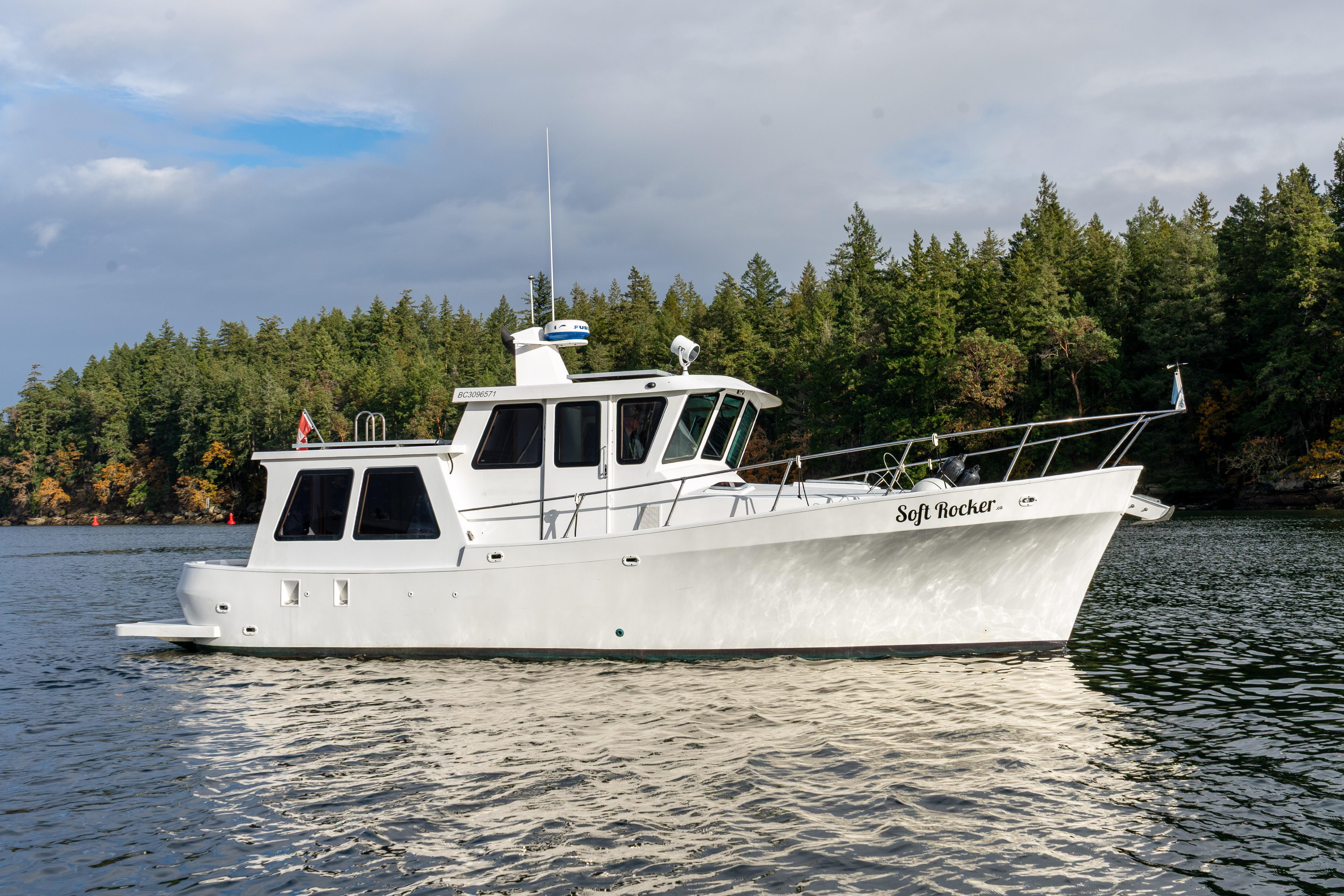 2014 Farrell 34 Pilothouse boat on calm water, surrounded by lush green trees.