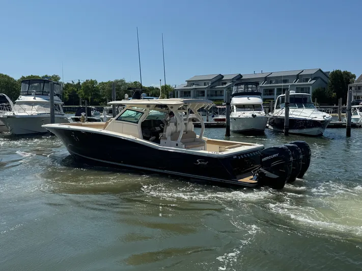  Yacht Photos Pics 2018 Scout 380 LXF boat with Mercury engines docked at a marina.