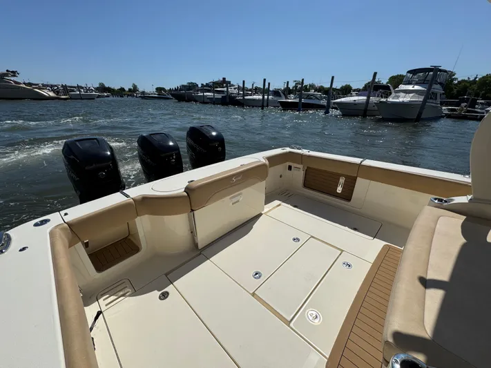  Yacht Photos Pics 2018 Scout 380 LXF boat with triple outboard engines docked at marina.