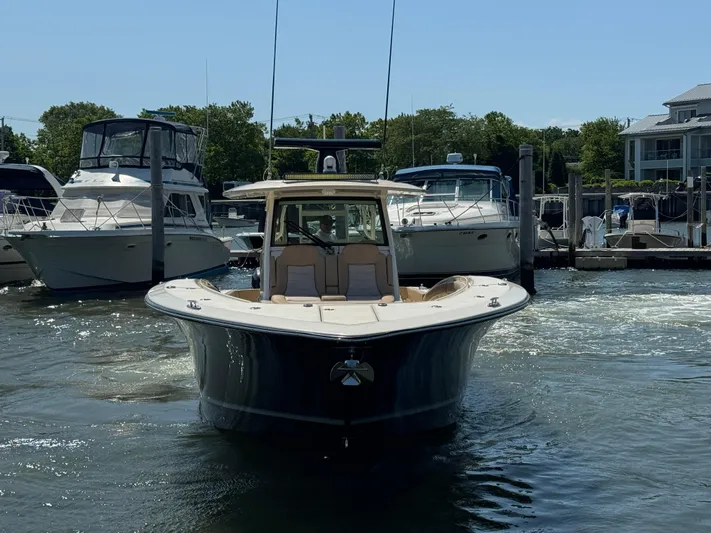  Yacht Photos Pics 2018 Scout 380 LXF boat docked at marina, surrounded by other vessels.