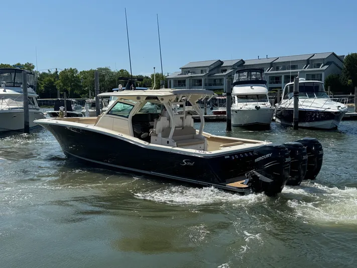  Yacht Photos Pics 2018 Scout 380 LXF boat with triple Mercury engines in a marina setting.