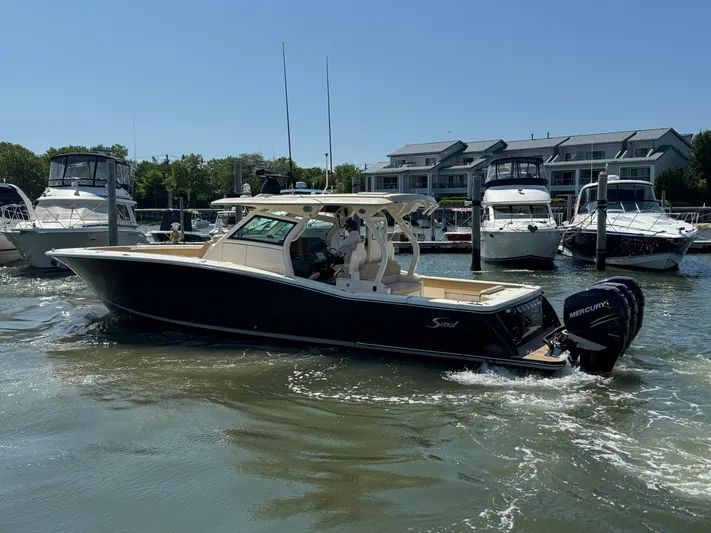  Yacht Photos Pics 2018 Scout 380 LXF boat docked in marina with other vessels.