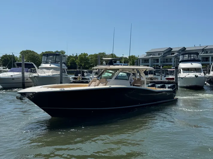  Yacht Photos Pics 2018 Scout 380 LXF boat docked in a marina with other vessels.
