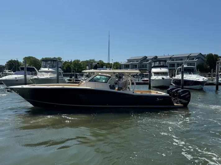  Yacht Photos Pics 2018 Scout 380 LXF boat docked at marina with other vessels in background.