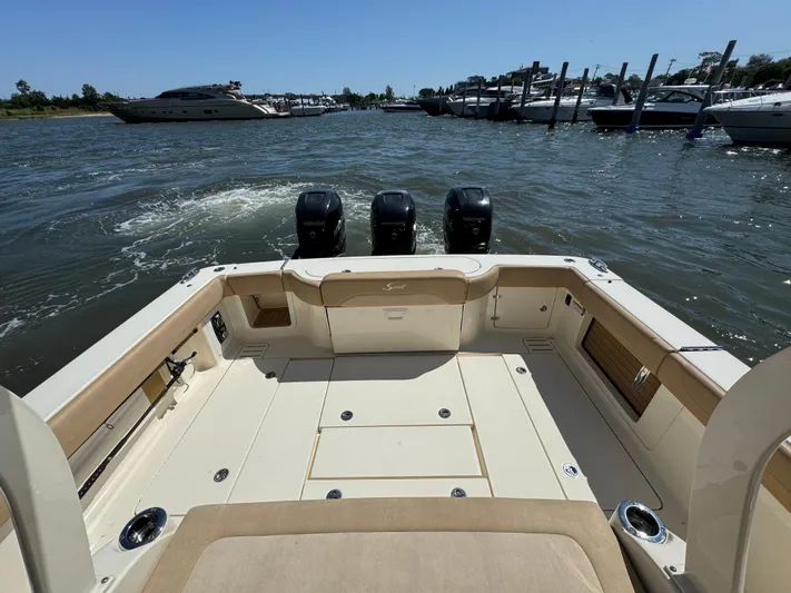  Yacht Photos Pics 2018 Scout 380 LXF boat with triple engines, docked in a marina.