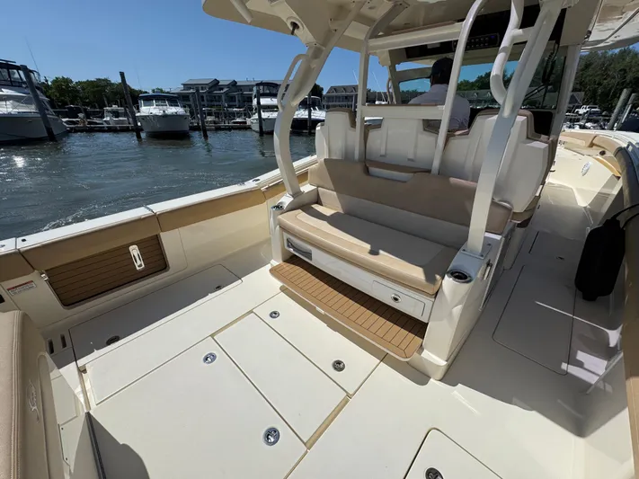  Yacht Photos Pics 2018 Scout 380 LXF boat interior with seating and storage, docked at a marina.