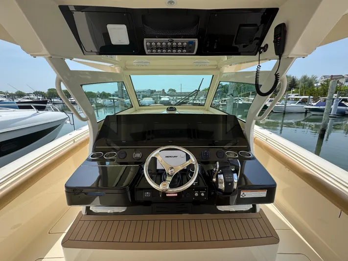  Yacht Photos Pics 2018 Scout 380 LXF boat helm with advanced controls and marina view.