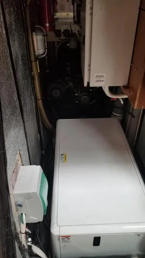  Yacht Photos Pics Engine room of a 2003 CNB 64 yacht, featuring mechanical equipment and wiring.