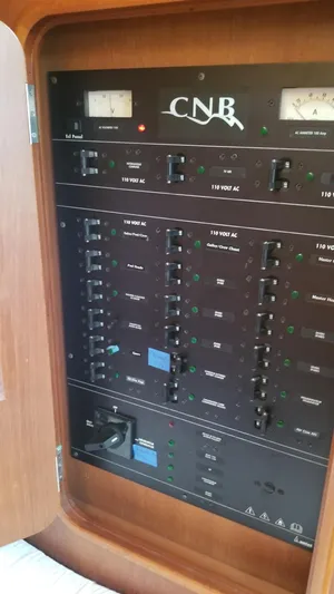  Yacht Photos Pics Electrical panel of a 2003 CNB 64 yacht, featuring various switches and meters.