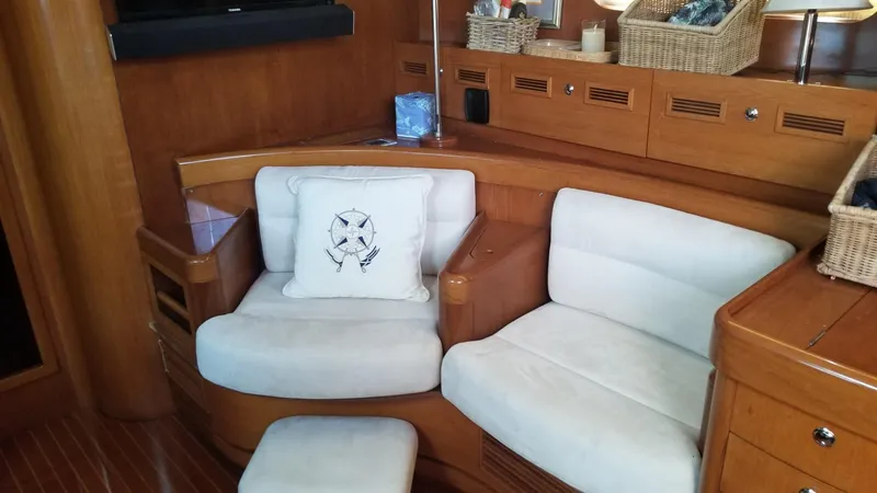  Yacht Photos Pics Luxurious CNB 64 yacht interior with cozy seating and nautical-themed decor.