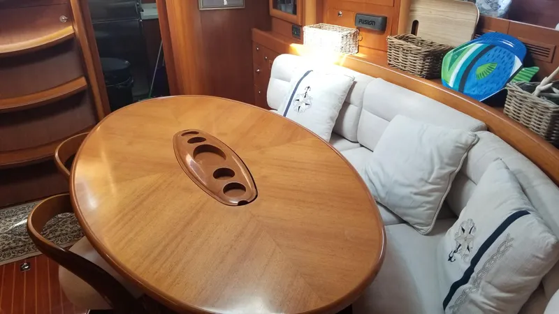  Yacht Photos Pics Luxurious CNB 64 yacht interior with wooden table, cushioned seating, and nautical decor.