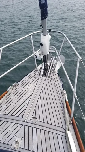  Yacht Photos Pics Bow of 2003 CNB 64 yacht with teak decking on calm water.