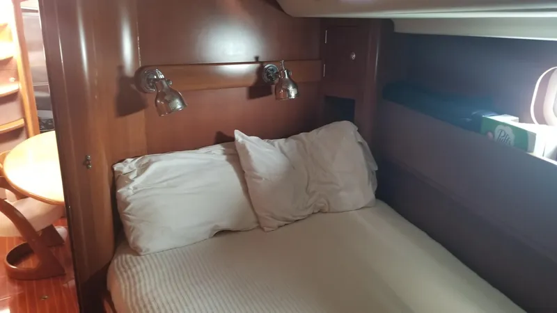  Yacht Photos Pics Cozy cabin interior of 2003 CNB 64 yacht with bed and reading lights.