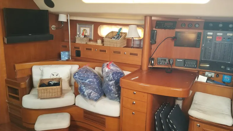  Yacht Photos Pics Luxurious interior of 2003 CNB 64 yacht with seating, navigation equipment, and storage baskets.