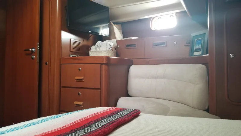  Yacht Photos Pics Interior of 2003 CNB 64 yacht with cozy seating and wooden cabinetry.