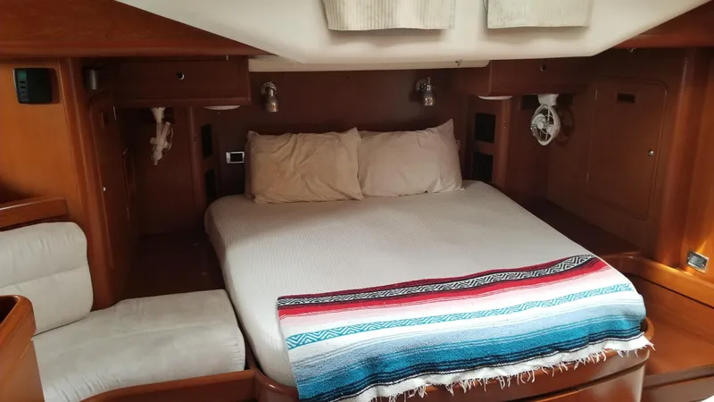  Yacht Photos Pics Luxurious cabin interior of 2003 CNB 64 yacht with cozy bed and wooden finish.