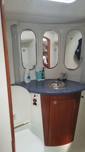  Yacht Photos Pics Bathroom interior of 2003 CNB 64 yacht with sink, mirrors, and toiletries.