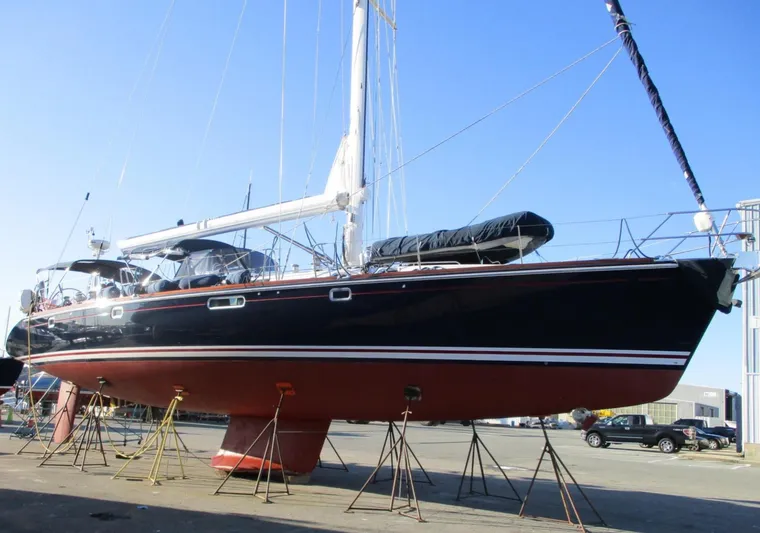  Yacht Photos Pics 2003 CNB 64 sailboat on stands, black hull, red bottom, in shipyard.