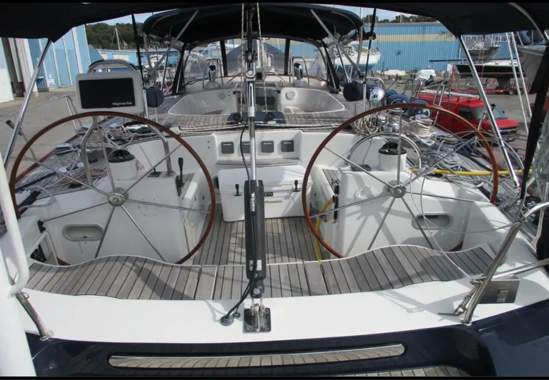  Yacht Photos Pics CNB 64 yacht cockpit with dual steering wheels, 2003 model, docked at marina.