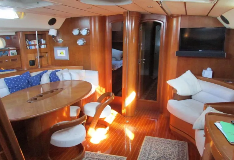  Yacht Photos Pics Luxurious interior of 2003 CNB 64 yacht with wooden furnishings and cozy seating area.