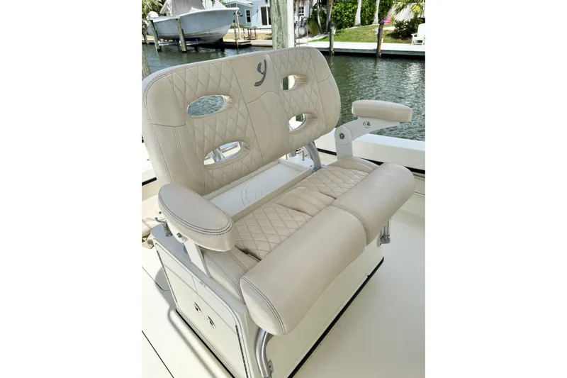  Yacht Photos Pics Luxurious beige seating on 2018 Young Boats 27, featuring diamond stitching and armrests.