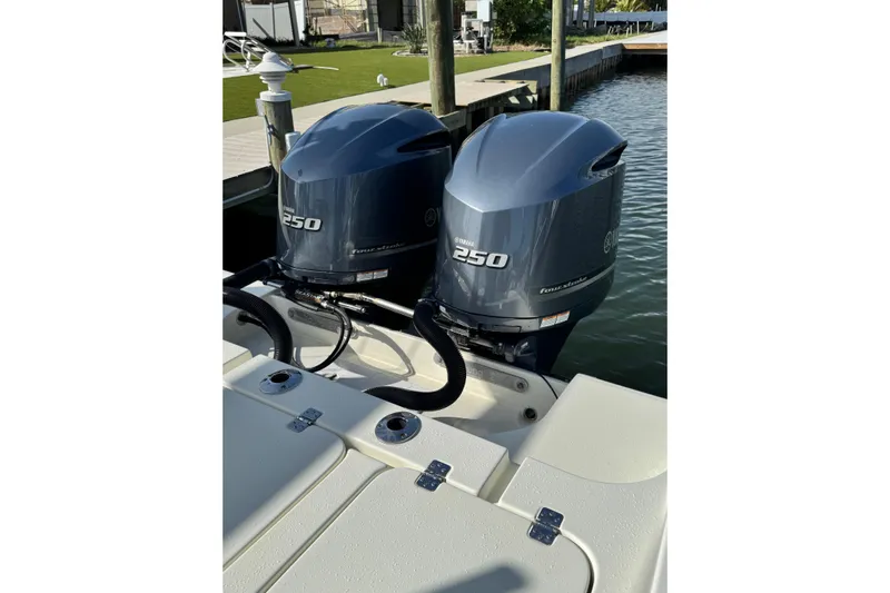  Yacht Photos Pics Twin Yamaha 250 outboard engines on a 2018 Young Boats 27, docked by the water.