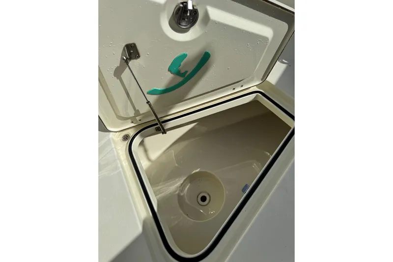  Yacht Photos Pics Open storage compartment on 2018 Young Boats 27, featuring a secure latch and drainage system.