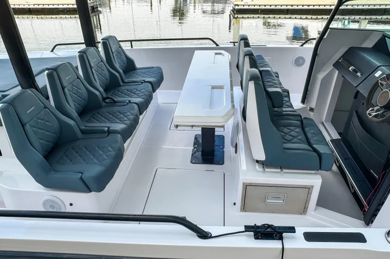  Yacht Photos Pics 2022 Axopar 37 Sun-Top boat interior with luxurious seating and table setup.