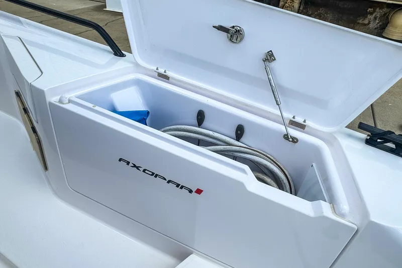  Yacht Photos Pics Open storage compartment on 2022 Axopar 37 Sun-Top boat, featuring coiled rope inside.