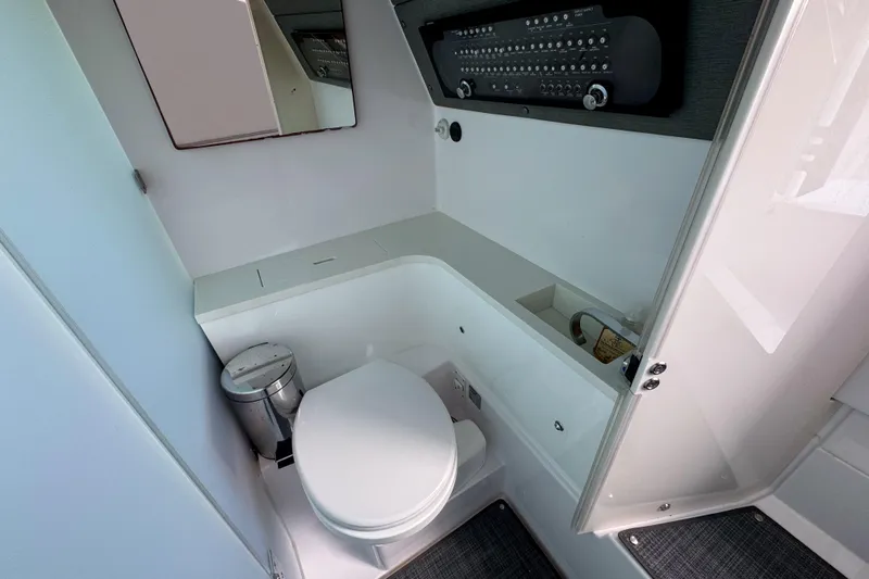  Yacht Photos Pics 2022 Axopar 37 Sun-Top boat bathroom with modern fixtures and compact design.