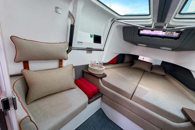  Yacht Photos Pics Luxurious interior of 2022 Axopar 37 Sun-Top boat with cozy seating and bedding.
