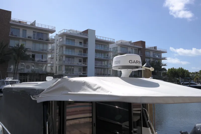  Yacht Photos Pics Jeanneau NC1095 boat docked near modern apartments, 2020 model.