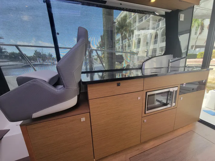  Yacht Photos Pics Interior of 2020 Jeanneau NC1095 boat with modern kitchen and seating area.