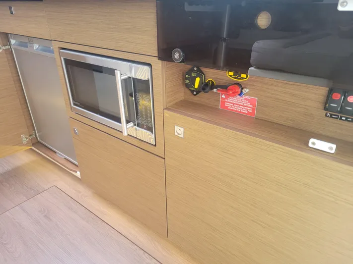  Yacht Photos Pics Interior of 2020 Jeanneau NC1095 boat featuring a microwave and control panel.