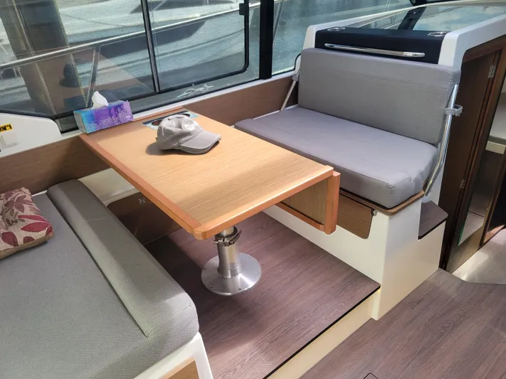  Yacht Photos Pics Interior of 2020 Jeanneau NC1095 boat with seating and table.