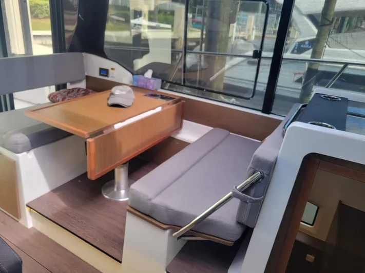  Yacht Photos Pics Interior of 2020 Jeanneau NC1095 boat with seating and table.