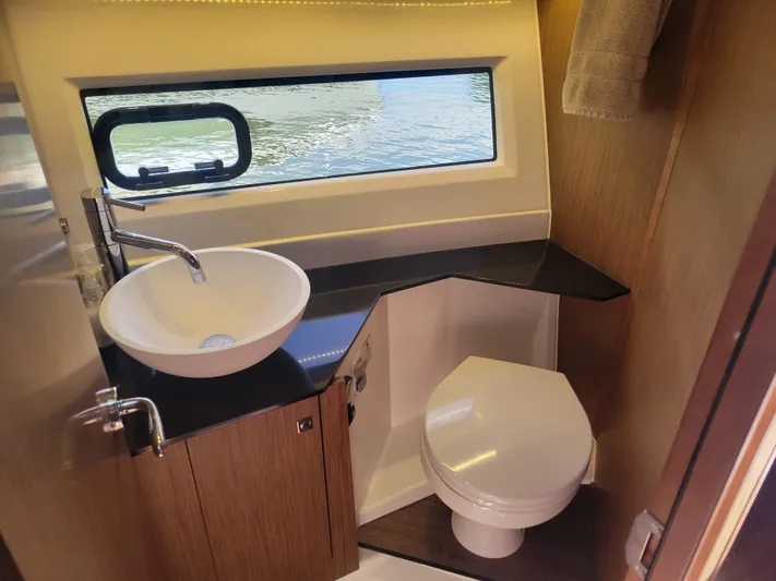  Yacht Photos Pics Modern bathroom in 2020 Jeanneau NC1095 boat with sink, toilet, and window view.