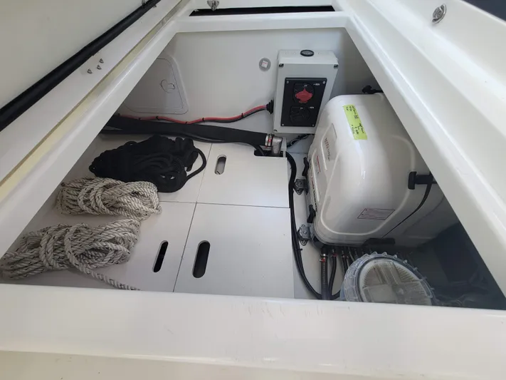  Yacht Photos Pics Storage compartment of 2020 Jeanneau NC1095 boat with ropes and equipment.