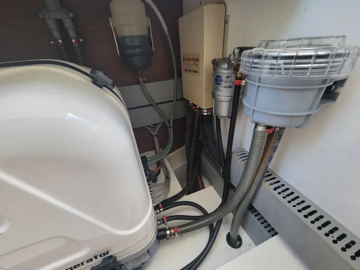  Yacht Photos Pics Engine compartment of a 2020 Jeanneau NC1095 boat, showcasing various mechanical components and hoses.