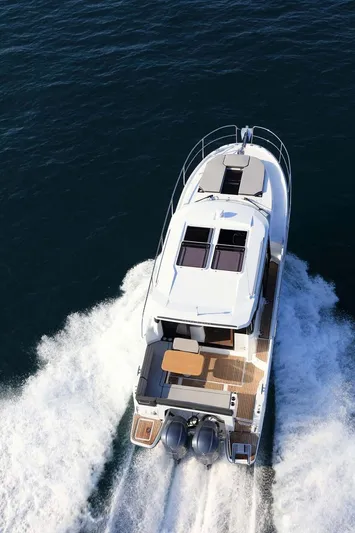  Yacht Photos Pics 2020 Jeanneau NC1095 cruising on open water, aerial view.