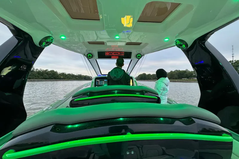  Yacht Photos Pics 2024 Deep Impact 399 Sport boat interior with green LED lighting on the water.