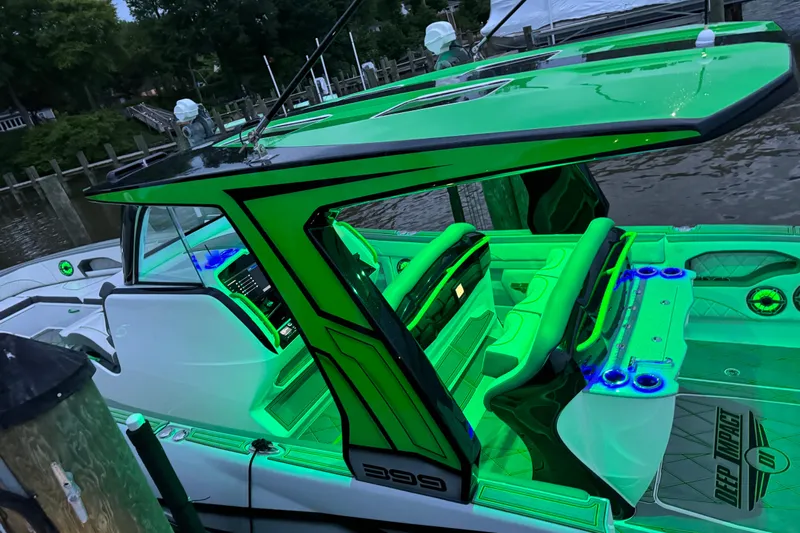  Yacht Photos Pics 2024 Deep Impact 399 Sport boat with vibrant green interior lighting at a dock.