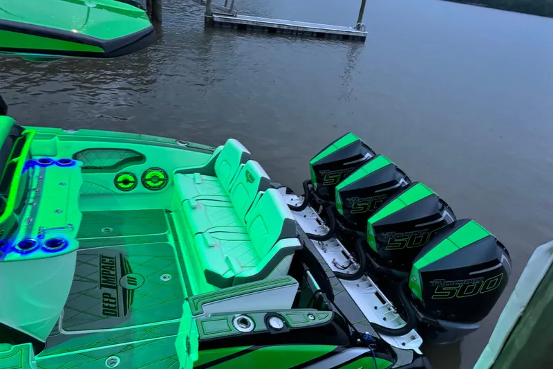  Yacht Photos Pics 2024 Deep Impact 399 Sport boat with vibrant green interior and four powerful outboard engines.