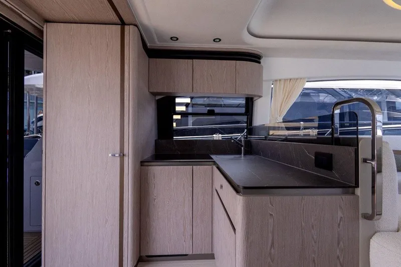  Yacht Photos Pics Modern kitchen interior of 2025 Azimut Fly 53 yacht with sleek cabinetry and countertops.