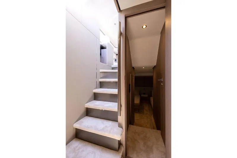  Yacht Photos Pics Interior staircase of 2025 Azimut Fly 53 yacht, featuring modern design and lighting.