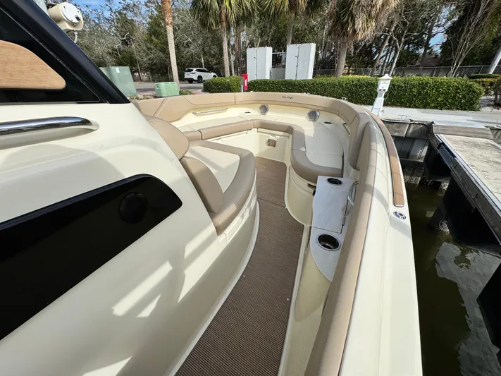  Yacht Photos Pics 2025 Chris-Craft Catalina 28 boat interior with beige seating and cup holders.