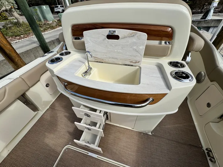  Yacht Photos Pics 2025 Chris-Craft Catalina 28 boat interior with sink, storage drawers, and cup holders.